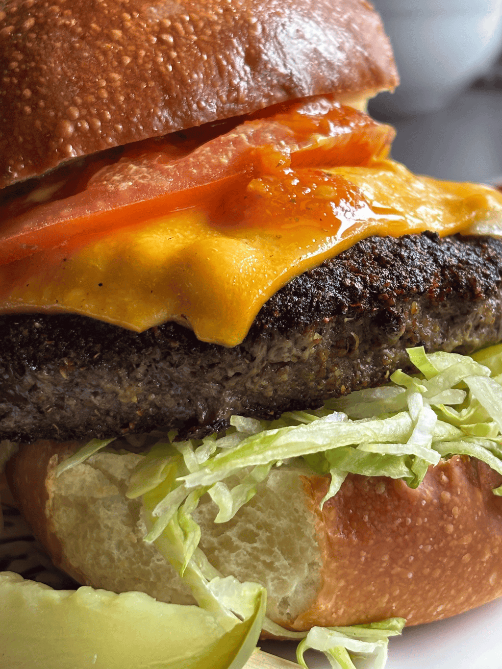 Pepper Dem hot sauce drizzled over a burger